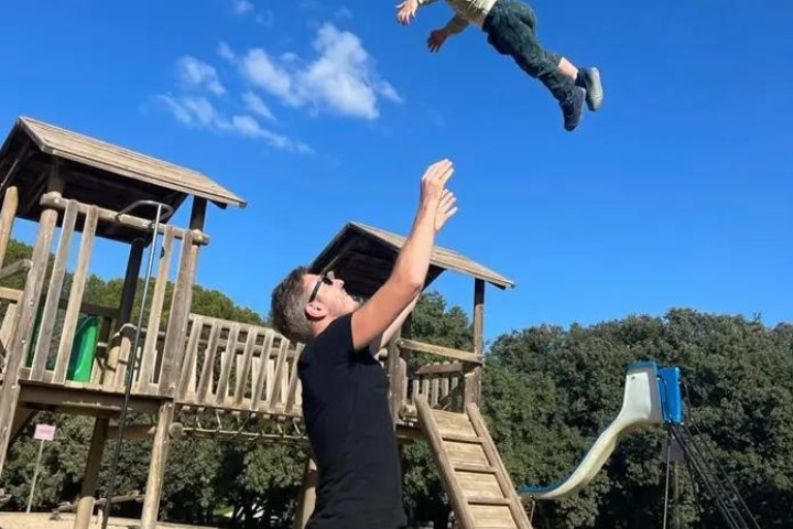 Alex throwing his kid in the air 