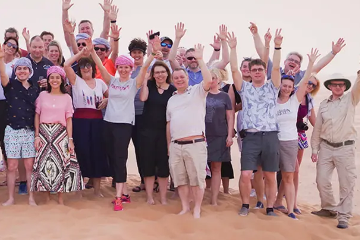 Boris and a group of people posing in what appears to be a desert