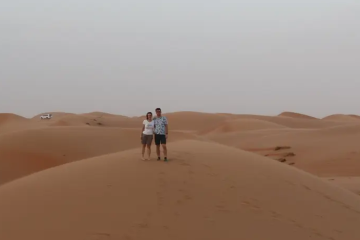 Boris and a woman posing in a desert