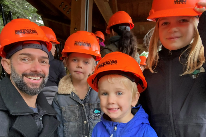 Matthew and his family wearing orange hats