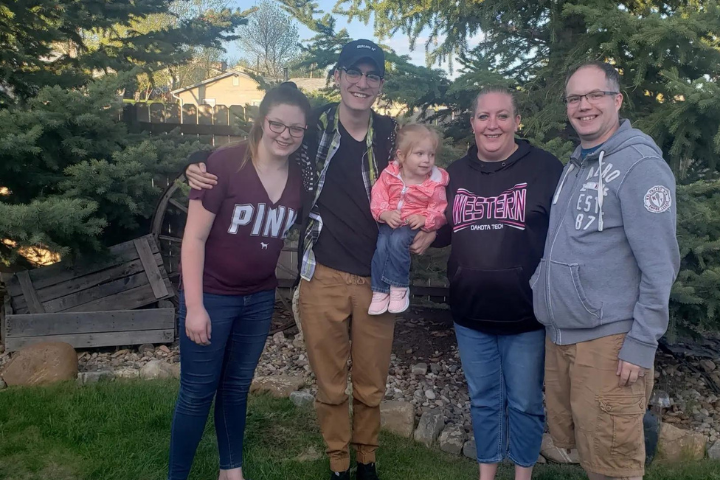 Nick and his family outdoors in a park