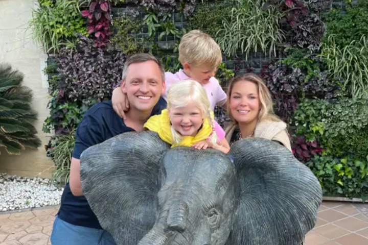Tina and her family posing with an elephant statue / sculpture