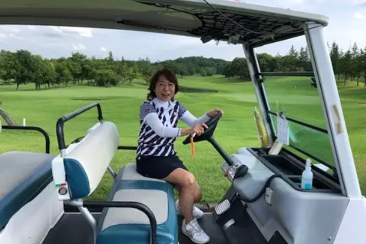 Yuko in a golf car