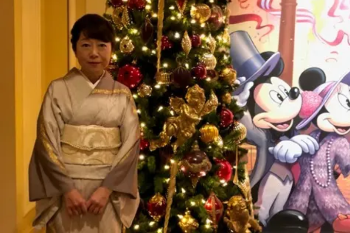 Yuko in front of a Christmas tree