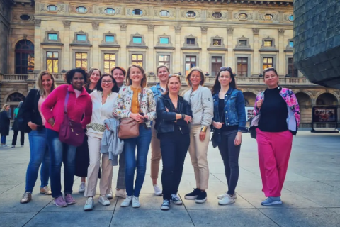 Katka and her team posing in front of a building