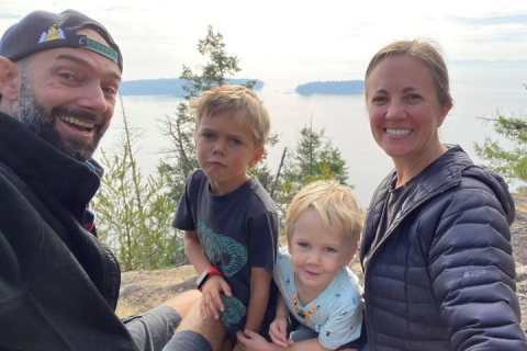 Matthew and his family in front of a lake