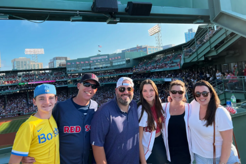 Nicole and her family at a sports stadium