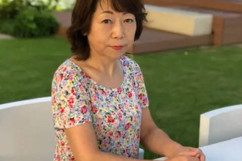 Yuko sat in a garden