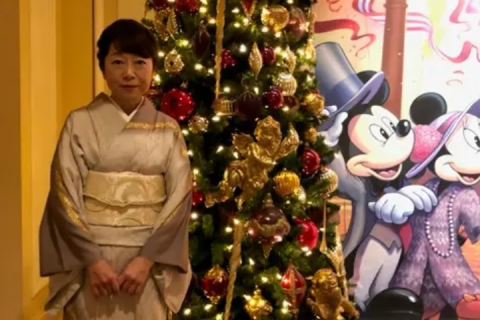 Yuko in front of a Christmas tree